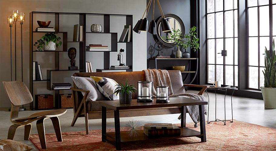 Industrial design endures because it’s easy to mix, match and accessorize. Wood furniture, bold lighting and metal decor are softened with pillows, blankets and rugs.