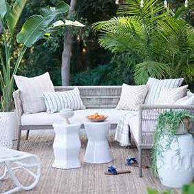 A modern coastal outdoor seating set with accent furniture. Links to where to shop coastal outdoor furniture and decor.